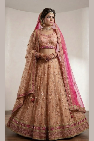 Bride in peach embroidered bridal lehenga with pink dupatta draped over head