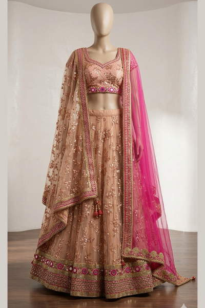 Blush peach bridal lehenga with hot pink dupatta, front view on display