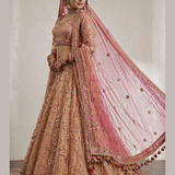 Peach bridal lehenga side view showing hot pink dupatta and embroidered skirt