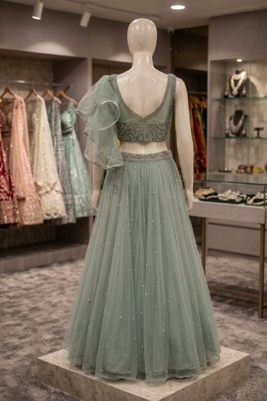 Dusty mint lehenga back view on display showing ruffled dupatta detailing