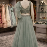 Dusty mint lehenga back view on display showing ruffled dupatta detailing