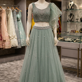 Dusty mint embellished lehenga, front view on display