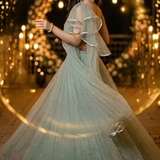 Woman twirling in dusty mint lehenga with flowing ruffled dupatta
