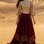 Woman in wine and beige fusion skirt set, standing in the desert