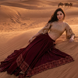 Wine and beige draped skirt set against a desert sunset backdrop