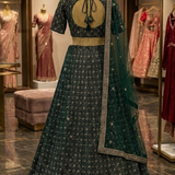 Deep emerald green embroidered lehenga, back view on display