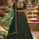 Emerald green lehenga back view showing dupatta and skirt embroidery