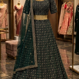 Deep emerald green embroidered lehenga, front view on display