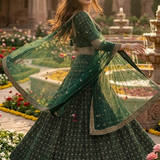Woman in emerald lehenga in motion, dupatta flowing
