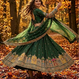 Model twirling Emerald Green Lehenga showcasing artistic embroidered border 