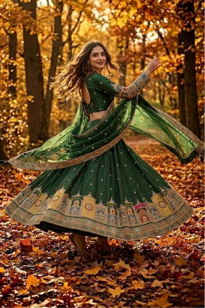 Model twirling Emerald Green Lehenga showcasing artistic embroidered border 