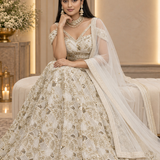 Ivory gold bridal lehenga with sequin embroidery, full length front seated pose