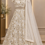Ivory gold bridal lehenga front view on display showing dupatta drape