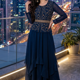 Woman in midnight blue embroidered layered skirt set, city skyline backdrop