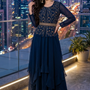 Woman in midnight blue embroidered layered skirt set, city skyline backdrop