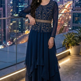 Woman standing in midnight blue embroidered skirt set, city view at night