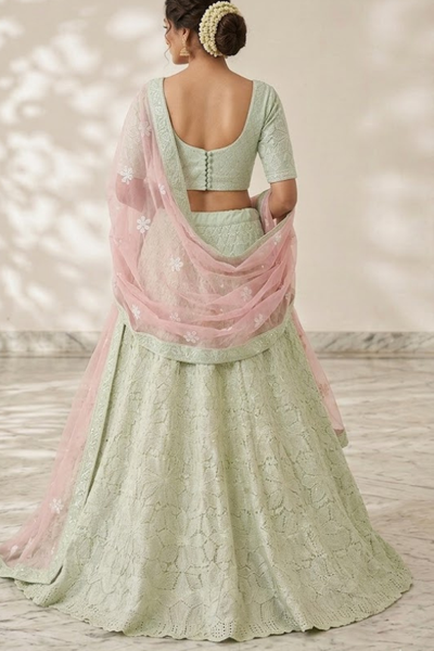 Mint green lehenga back view showing blouse design and pink dupatta