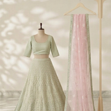 Mint green lehenga with blush pink dupatta, front view on display