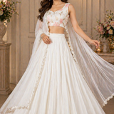 Model in white flowy lehenga with sheer dupatta, front view