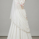Close view of white floral lehenga fabric and lace-edged dupatta detailing