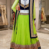Neon lime lehenga back view on display showing navy embroidered blouse