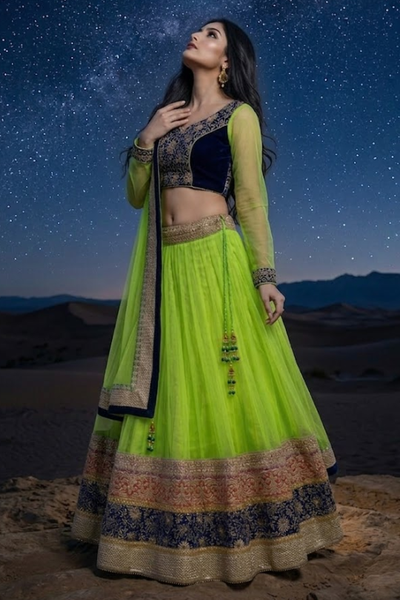Neon lime lehenga with navy embroidered border, front pose