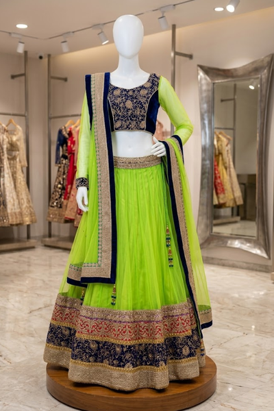 Neon lime and navy blue designer lehenga, front view on display