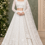 Pearl white bridal lehenga with sheer sleeves and floral embroidery, front pose