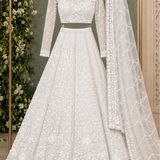 Pearl white bridal lehenga front view on display showing sheer dupatta hanged 