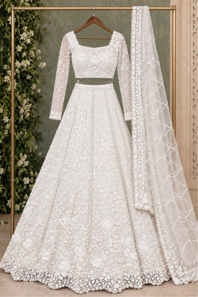 Pearl white bridal lehenga front view on display showing sheer dupatta hanged 