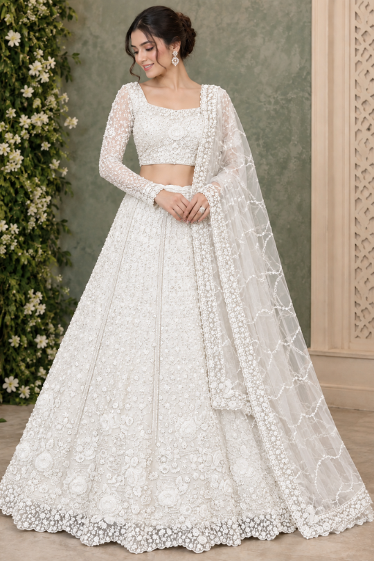Bride in pearl white floral embroidered bridal lehenga with sheer dupatta, front view