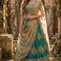 Bride in rama green and gold embroidered lehenga with net dupatta, front view