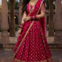 Bride in rani pink festive lehenga with golden zari embroidery, front view