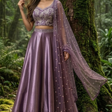 Woman in royal amethyst embroidered lehenga, forest backdrop