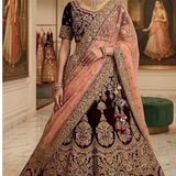 Bride in maroon and peach bridal lehenga with gold embroidery, front view