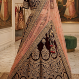 Maroon and peach bridal lehenga on mannequin showing gold embroidered lehenga choli and dupatta