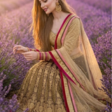 Mocha and gold embroidered lehenga with pink accents, lavender field portrait