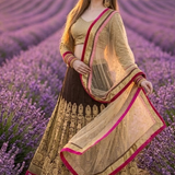 Woman in mocha lehenga standing amid a wide lavender field