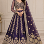 Bride in royal purple zari embroidered bridal lehenga with sheer dupatta, front view