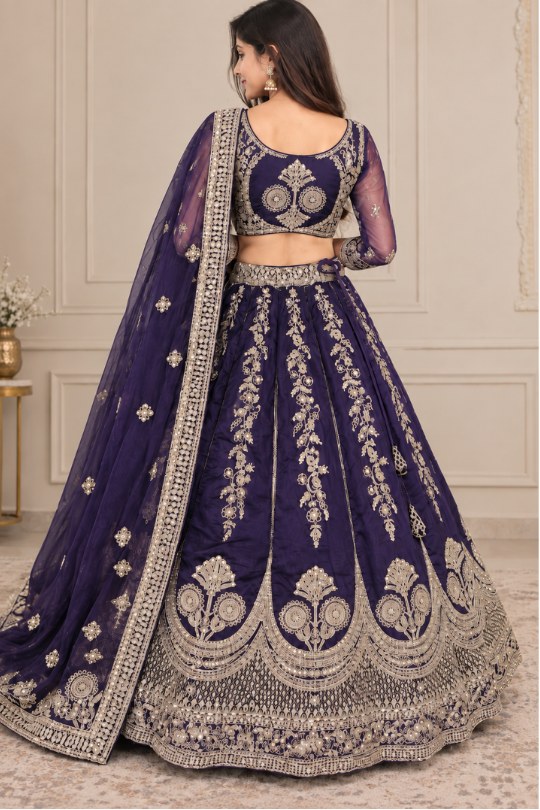 Royal purple bridal lehenga with golden embroidery, close portrait back view