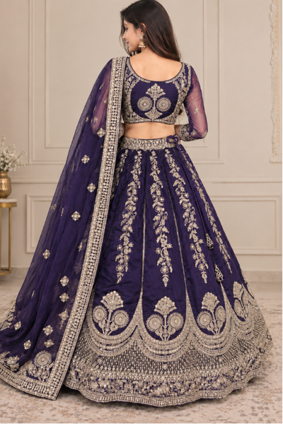 Royal purple bridal lehenga with golden embroidery, close portrait back view