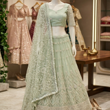 Sage green embroidered lehenga, front view on display