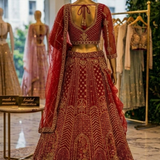 Scarlet bridal lehenga back view on display showing blouse and dupatta detailing