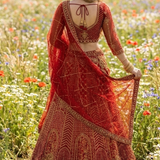 Scarlet bridal lehenga back view showing blouse tie-back and dupatta drape