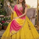 Seated view of Sunset Yellow Lehenga with pink ombre dupatta