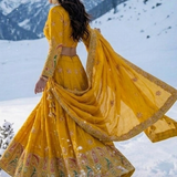 Sunshine Royale mustard lehenga set side view with draped dupatta and flared skirt