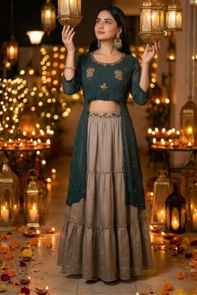 Woman in teal embroidered Indo-Western kurta skirt set, standing among lanterns