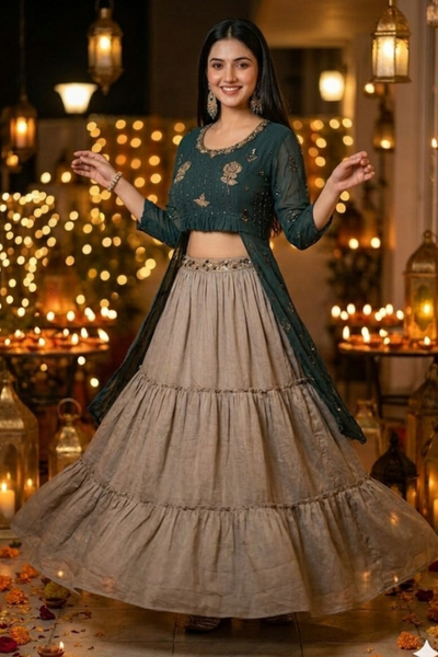 Woman in teal kurta skirt set in motion, festive lantern setting
