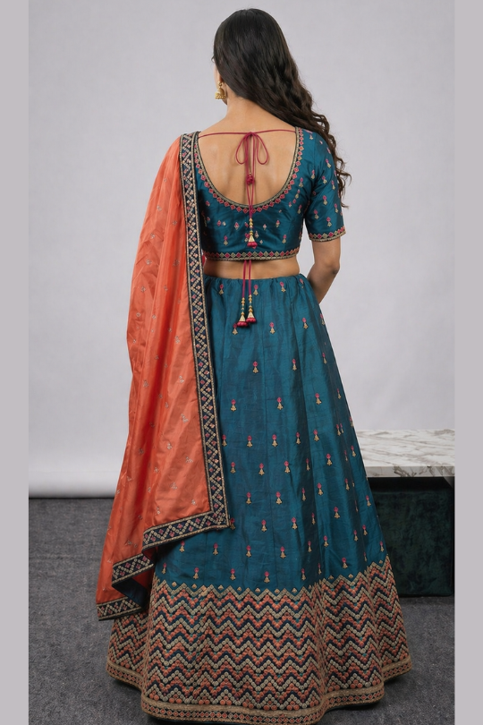 Teal lehenga back view showing blouse design and dupatta drape