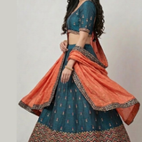 Teal blue lehenga side view with rust orange dupatta and embroidered border